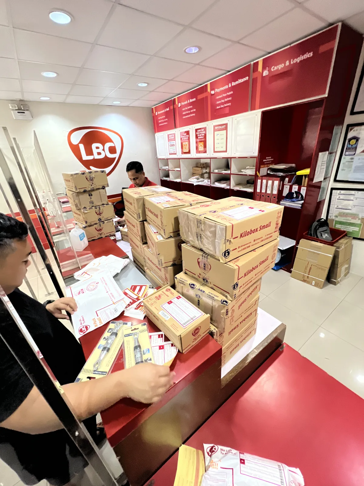 TardiGrade parcels being processed at an LBC counter